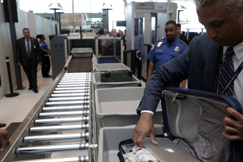 A TSA official inspects a bag at Terminal 4 of JFK airport in New York City. Photo: Reuters