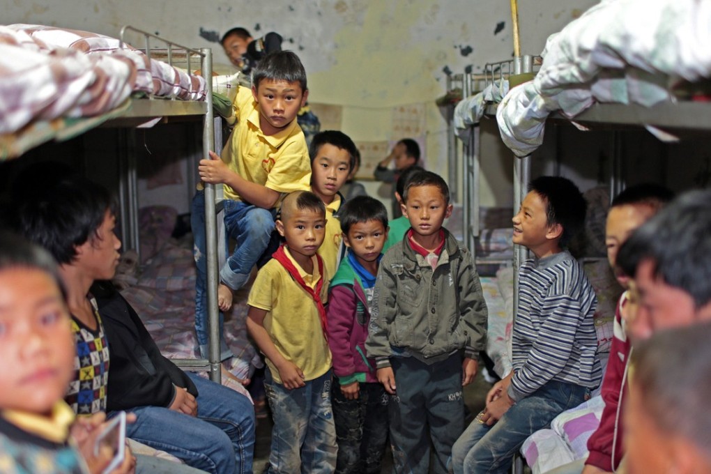 Students prepare for another day at Molong Primary School in a remote village in Yunnan province. The school includes 279 students who have been left behind by parents who moved to cities to seek work. Photo: Imaginechina