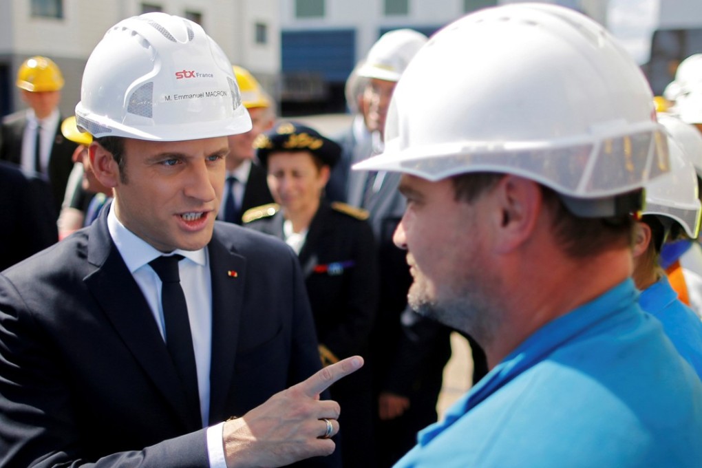 French President Emmanuel Macron (L) speaks to an employee during a visit to the STX Les Chantiers de l'Atlantique shipyard site in Saint-Nazaire, France. Photo: Reuters