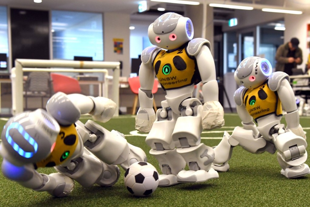 Three robots battle it out for the soccer ball in Sydney on July 21, as Australia’s five-time world champions of robot soccer, the University of New South Wales’ Runswift team, heads to Nagoya, Japan for the RoboCup World Championships this month. Photo: AFP