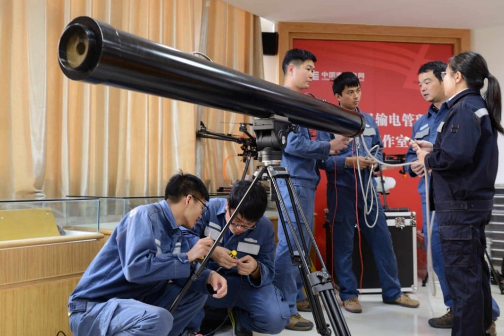 Power grid staff with the laser cannon. Photo: Handout