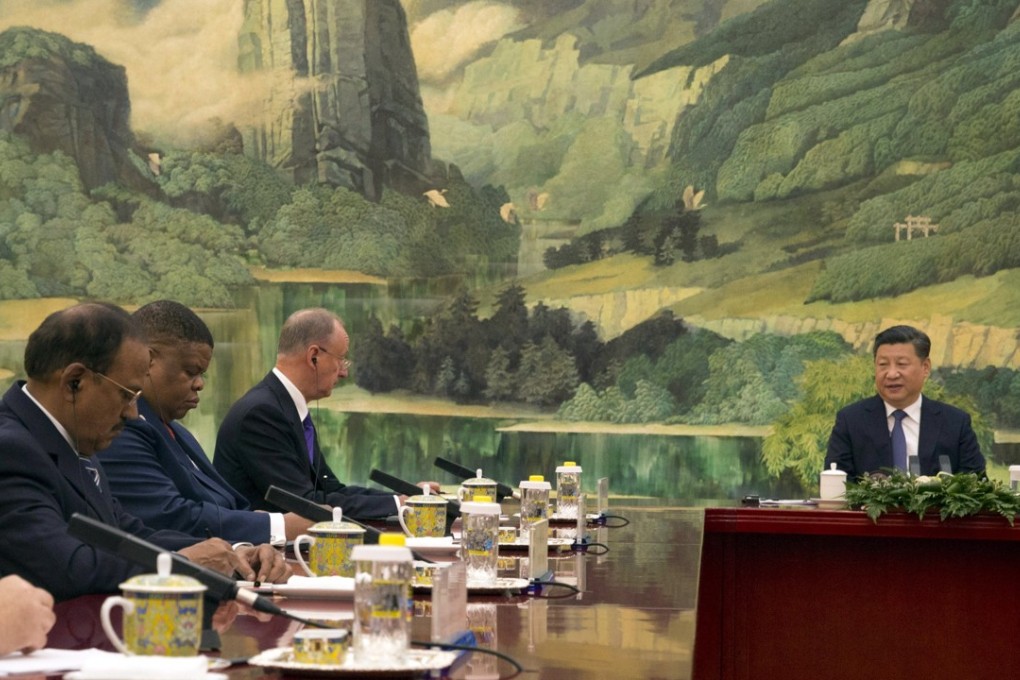 Indian National Security Adviser Ajit Doval (left), and President Xi Jinping attend a meeting at the Great Hall of the People in Beijing on Friday. Photo: EPA