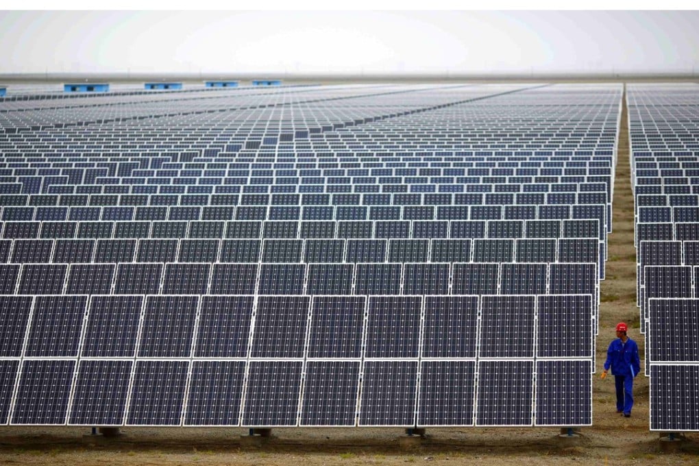 A worker inspects panels at a solar farm in Dunhuang, Gansu Province. The distance between the remote region and the majority of China’s recycling facilities adds to the cost of disposing of the panels once they have reached the end of their useful life. Photo: Reuters