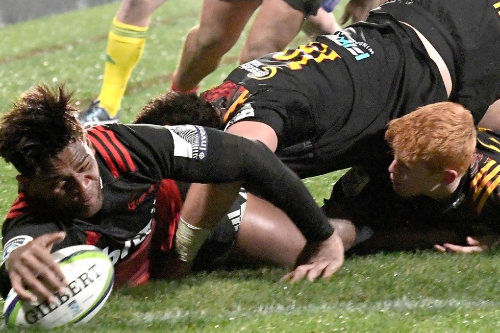 Canterbury Crusaders' Seta Tamanivalu (left) scores a try against the Waikato Chiefs. Photo: AFP