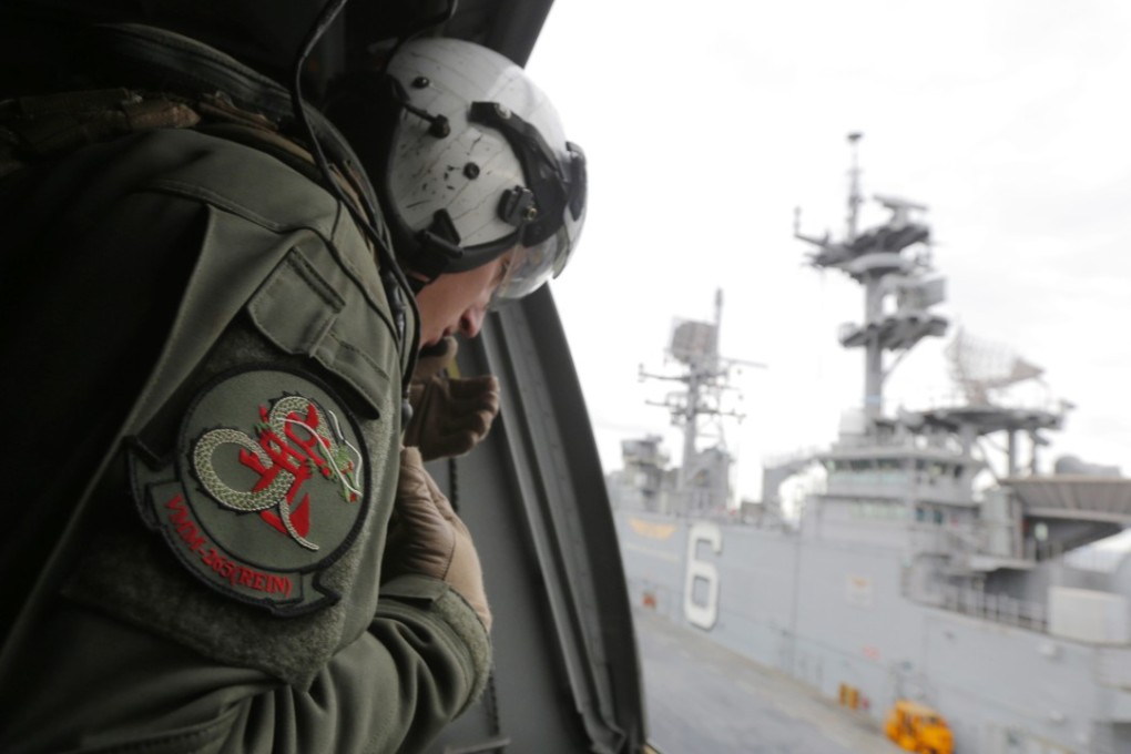 A crewman aboard a US Marine MV-22B Osprey aircraft looks out as it lifts off the deck of the USS Bonhomme Richard amphibious assault ship off the coast of Sydney, Australia, Thursday, June 29, 2017 after a ceremony on board the ship marking the start of Talisman Saber 2017, a biennial joint military exercise between the United States and Australia. Photo: AP