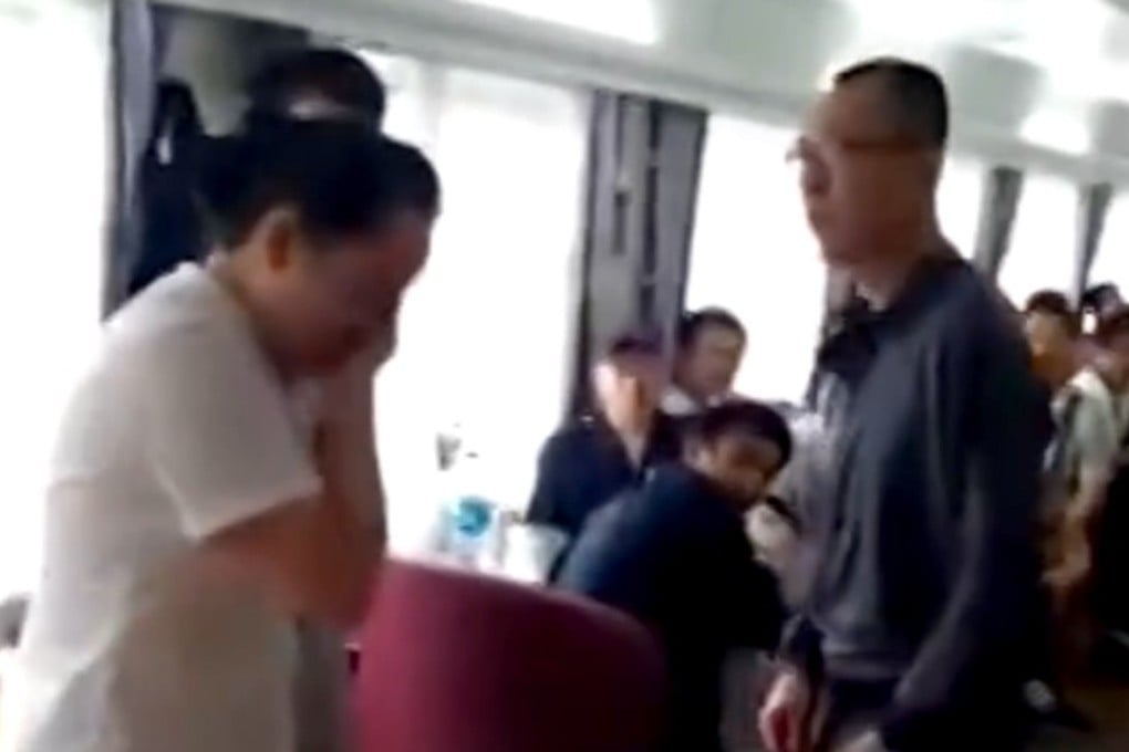 The waitress holds a hand to her face after being slapped by the angry passenger. Photo: Handout