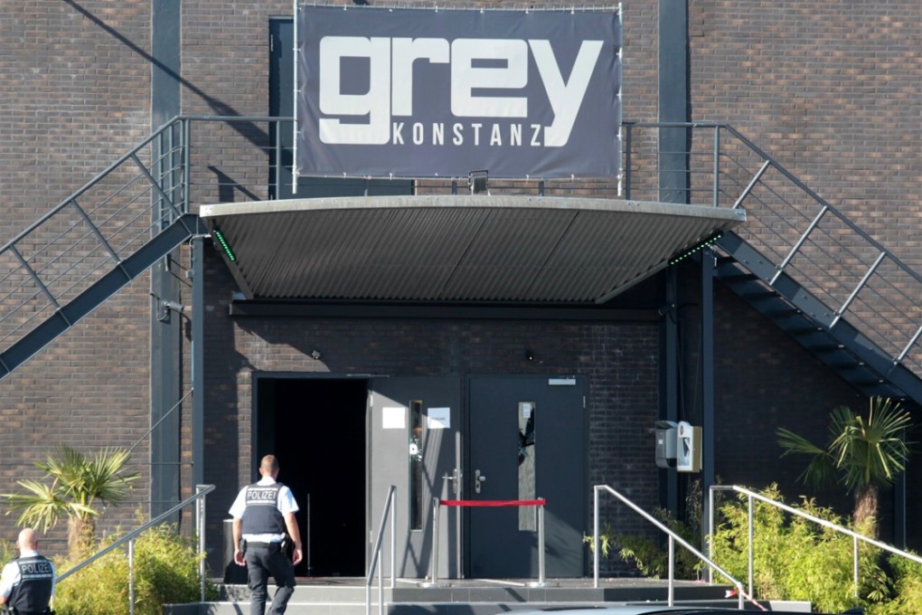 Police officers stand at the door of the nightclub 'Grey' in Konstanz, Germany. According to a police report a 34-year-old man shot at several people inside the club in the early morning. Photo: EPA