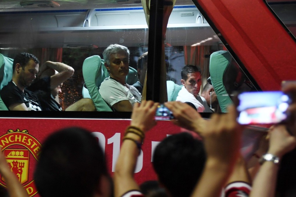 Manchester United coach Jose Mourinho watches China fans as his team bus passes by in Beijing in July 2016. Photo: AFP