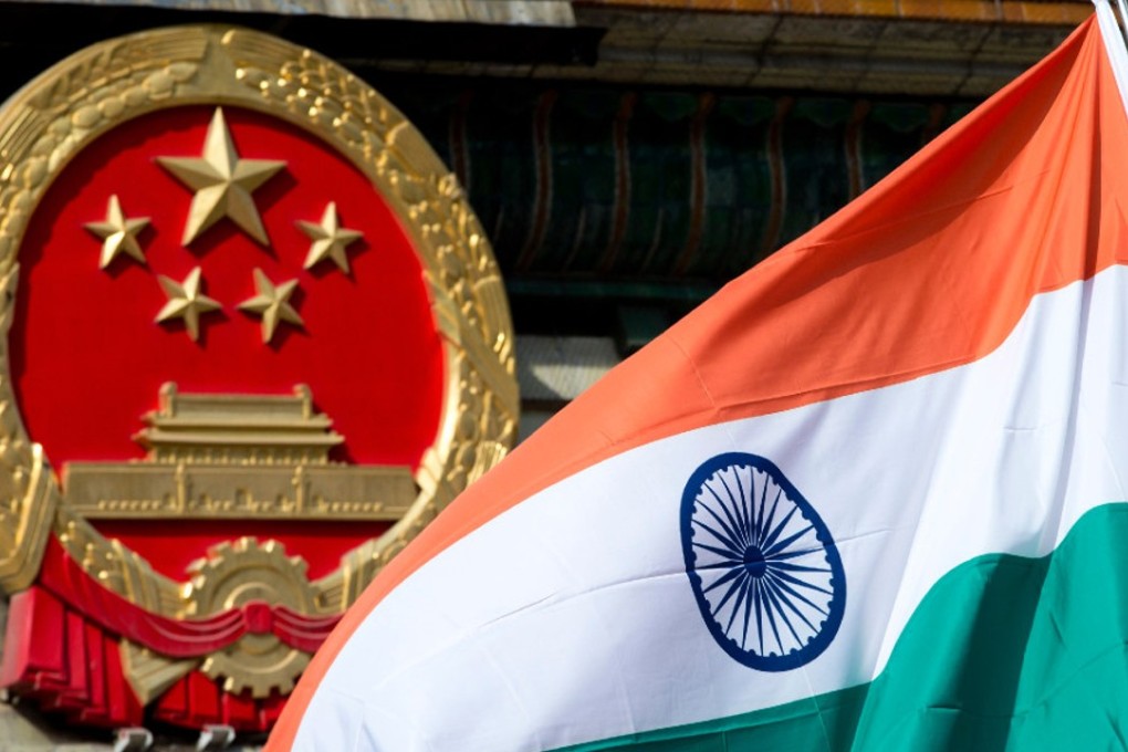 An Indian flag flies next to the Chinese national emblem outside the Great Hall of the People in Beijing. The ongoing dispute between India and China could hamper Beijing’s economic ambitions. Photo: AP