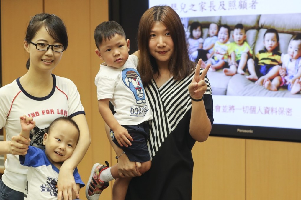 Ying and her son (left) pose with CE9 Parent Support Group head Helen Pang and her son in Queen Elizabeth Hospital. Photo: Edward Wong
