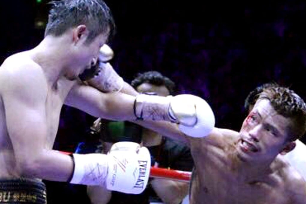 Sho Kimura lands a straight right against China’s Zou Shiming during their WBO flyweight title bout in Shanghai. Photo: Sho Kimura/Facebook