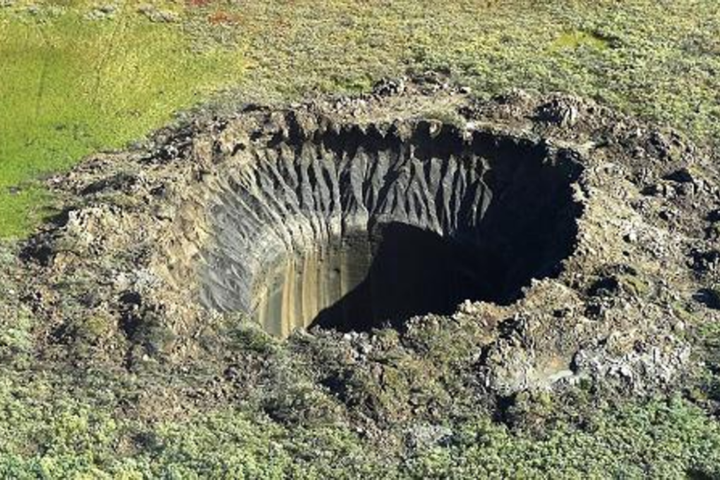 This photograph shows a crater on the Yamal Peninsula, northern Siberia, taken on August 25, 2014. Its formation is possibly linked to climate change. Photo: Vasily Bogoyavlensky/AFP
