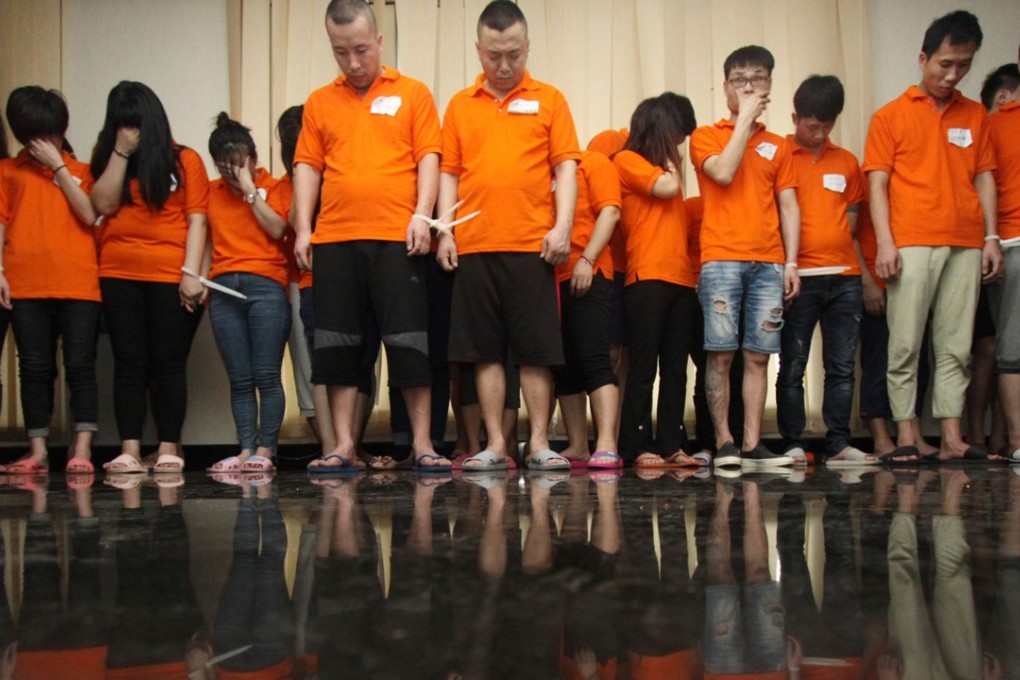 Some of the Chinese cyber crime suspects pictured at the Jakarta police headquarters. Photo: Reuters