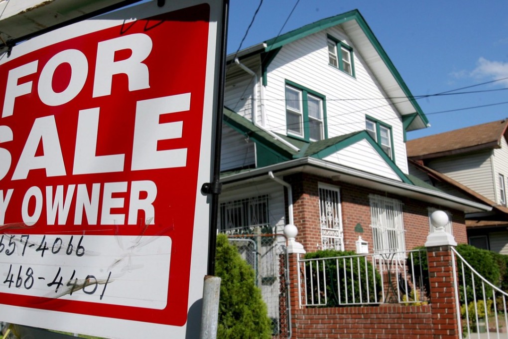 A file photo of a real estate sign in front of a house in Queens, New York. Photo: EPA