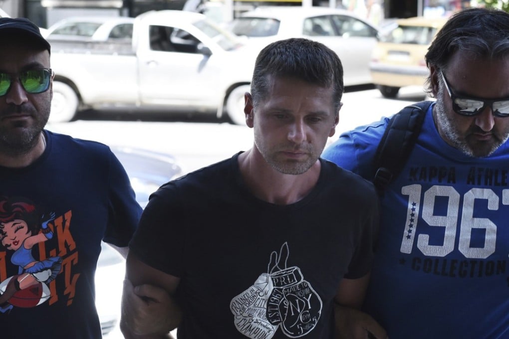 Russian national Alexander Vinnik, who allegedly defrauded early adopters of millions of pounds’ worth of bitcoins, is escorted by police officers as he arrives at a courthouse at the northern Greek city of Thessaloniki last Wednesday, July 26. Photo: AP