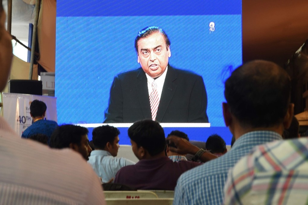 Shareholders watch India's richest man and oil-to-telecom conglomerate Reliance Industries chairman Mukesh Ambani speak during the company's 40th AGM in Mumbai. The tycoon has overtaken Li Ka-shing as Asia’s second richest man. Photo: AFP
