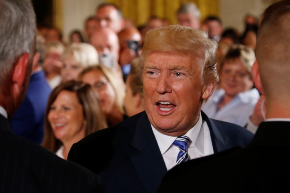 US President Donald Trump greets guests during an event with small businesses in the East Room of the White House. Trump has admitted having weighed in on the statement by his son on his meeting with a Russian lawyer. Photo: Reuters