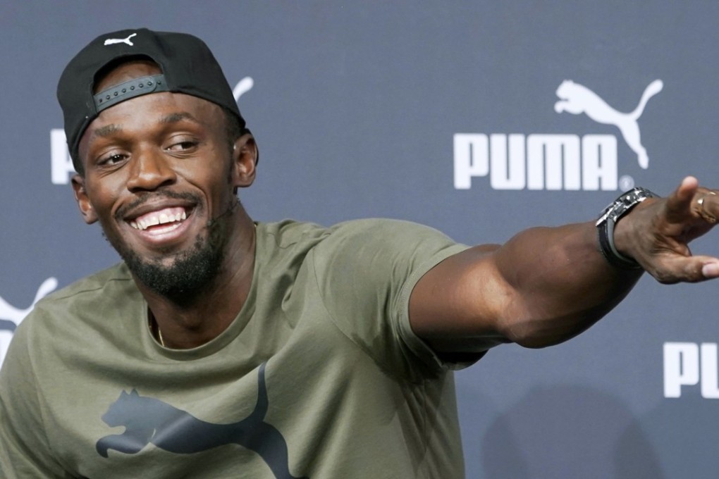 Usain Bolt points at a reporter to accept a question during a press conference in London. Photo: Kyodo