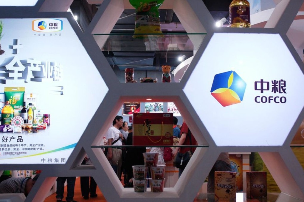 People visit the COFCO Corp booth. The Chinese commodities firm will take part in the bidding for a sugar mill in Brazil. Photo: Getty