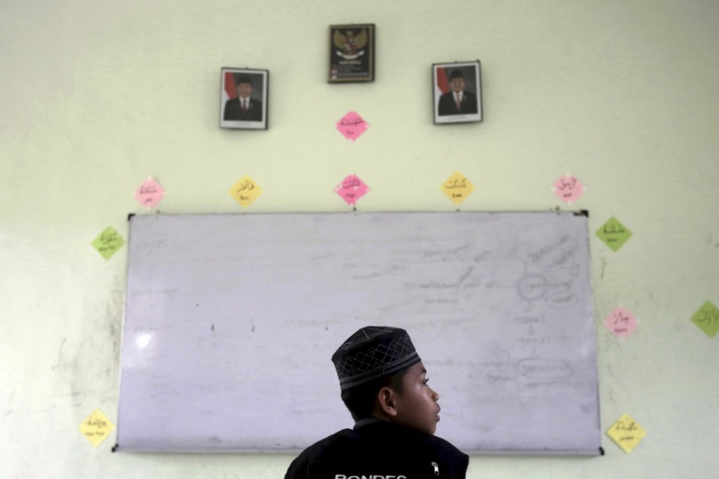 A student sits in a classroom at Al Hidayah Islamic Boarding School in Sei Mencirim. Photo: AP