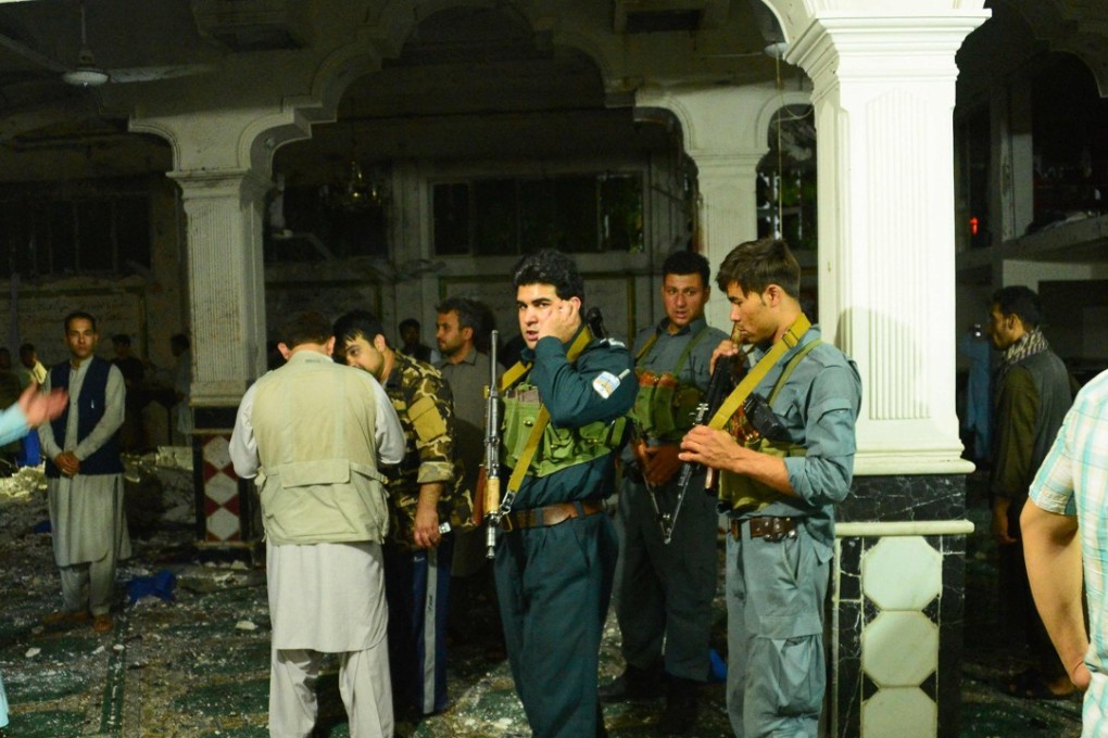 Afghan security personnel inspect the site of a suicide bomb attack at a Shiite mosque in Herat on August 1, 2017. A suicide bomber and a gunman killed more than 20 people at a Shiite mosque, the latest attack to highlight a deteriorating security situation in the country. Photo: AFP