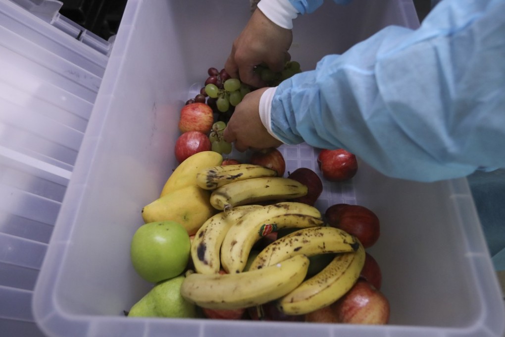 Workers packing excess food to give away in an effort to reduce waste. Hong Kong generates over 9,000 tonnes of municipal solid waste per day, of which a staggering third is food. Photo: Nora Tam