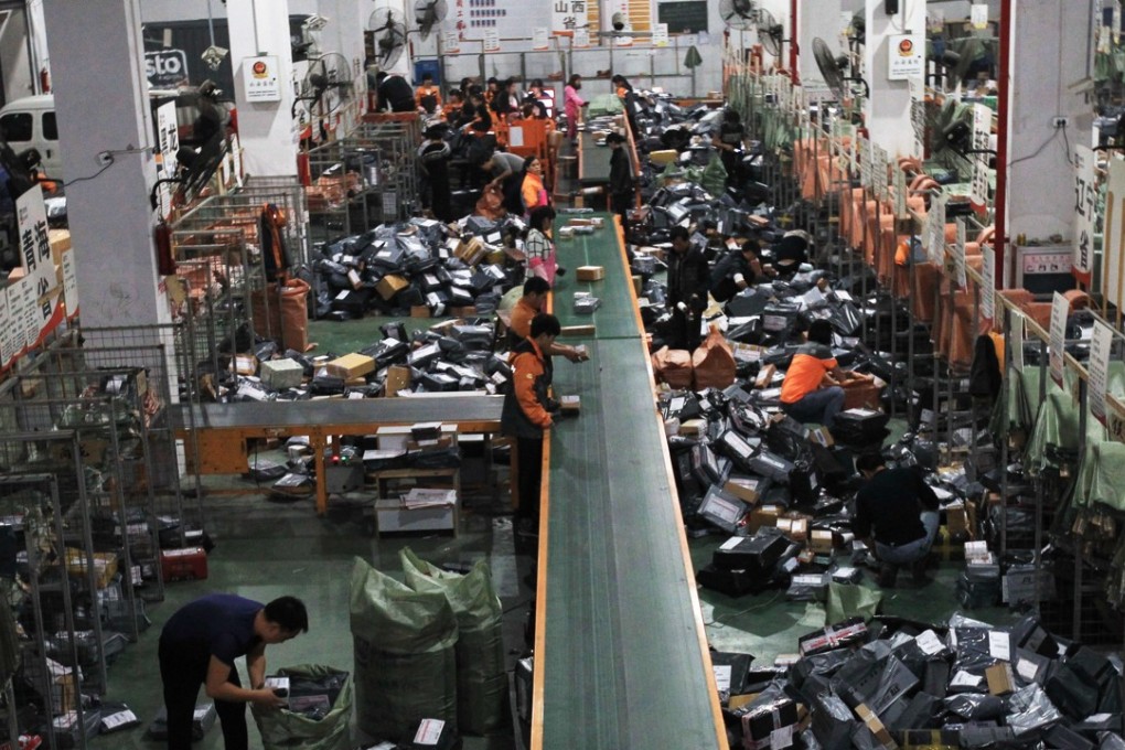 Staff members of STO Express sort out packages in Wenzhou, Zhejiang province. The number of delivered parcels in China jumped 51 per cent to 31.28 billion in 2016. Photo: Xinhua