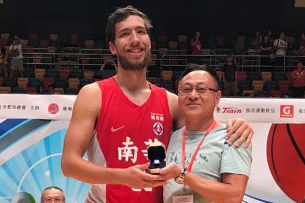 Duncan Reid is presented with the MVP award by Hong Kong Basketball Association official Chan Siu-wong after South China won the A1 Division championship. Photo: Chan Kin-wa