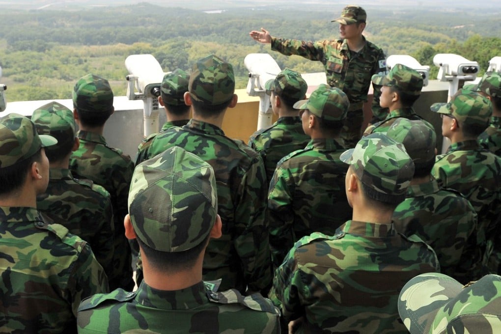 South Korean soldiers look at the North Korean side as they visit an observation post in Paju near the Demilitarised Zone (DMZ) dividing the two Koreas. Photo: AFP/JUNG YEON-JE