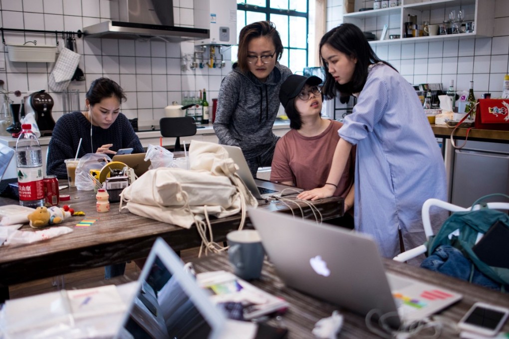 This picture taken on May 5, 2017 shows employees of the e-commerce startup "gogoand" working on their website in Shanghai. Hordes of Chinese millennials are speaking directly to the country's 700 million smartphone users, streaming their lives to lucrative effect, fronting brands and launching businesses. They are known as "wanghong" -- literally hot on the web -- and they now represent a multi-billion-dollar industry, becoming so big that it has its own university curriculum. At Yiwu Industrial & Commercial College, classrooms for the 34 mostly female students are typically dance studios, catwalks strafed by flashing lights, and bustling makeup rooms. / AFP PHOTO / Johannes EISELE / TO GO WITH Lifestyle-celebrity-retail-China-internet, FEATURE by Albee ZHANG