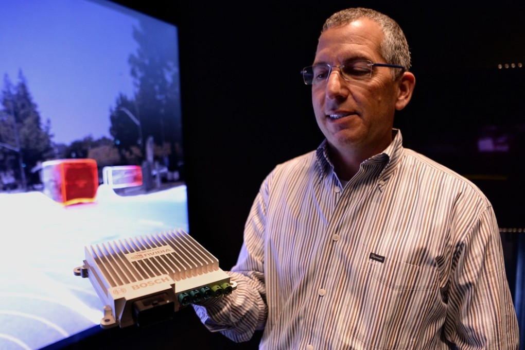 Danny Shapiro, senior director, holds the Nvidia Drive PX2 processor. Known for making processors for video games, Nvidia makes the "brains" behind most self-driving cars on the road today and is considered a leader in the self-driving car industry. Photo: TNS