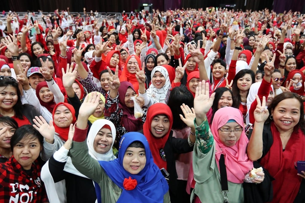 Indonesian domestic workers cheer at an event to meet visiting President Joko Widodo, at Hong Kong’s AsiaWorld Expo on April 30. Photo: Edward Wong