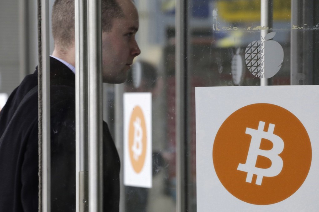 A man enters the Inside Bitcoins conference and trade show, in New York. A civil war between the techies that run bitcoin appears poised to cause significant disruption of the digital currency. Photo: Associated Press