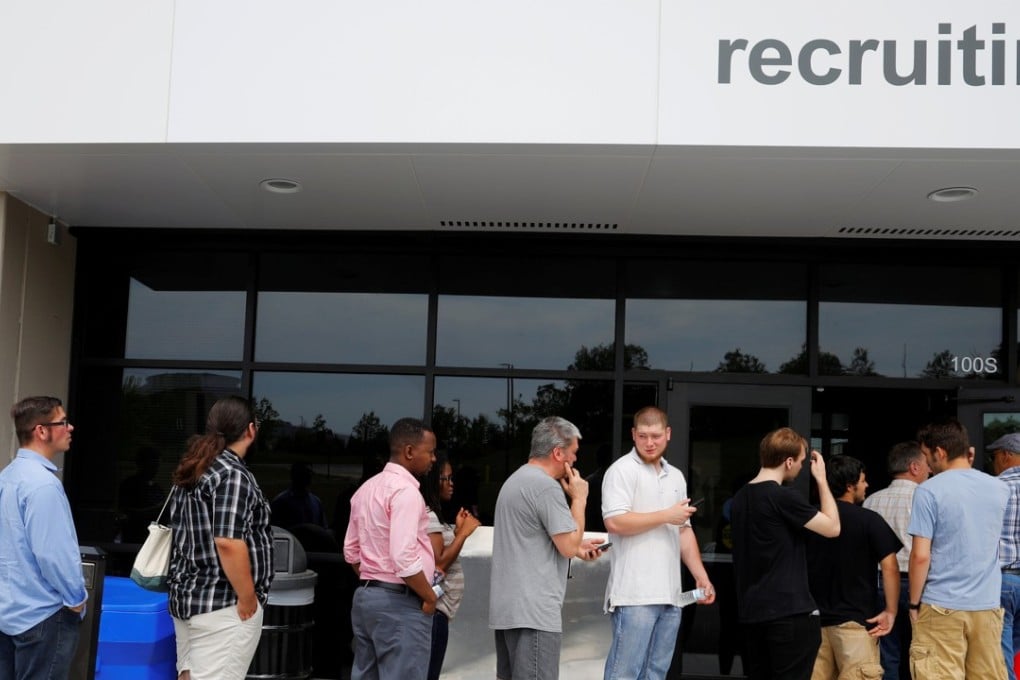 Job seekers line up to apply during "Amazon Jobs Day." US non-farm payrolls rose sharply in July and unemployment fell to near a 16-year low. Photo: Reuters