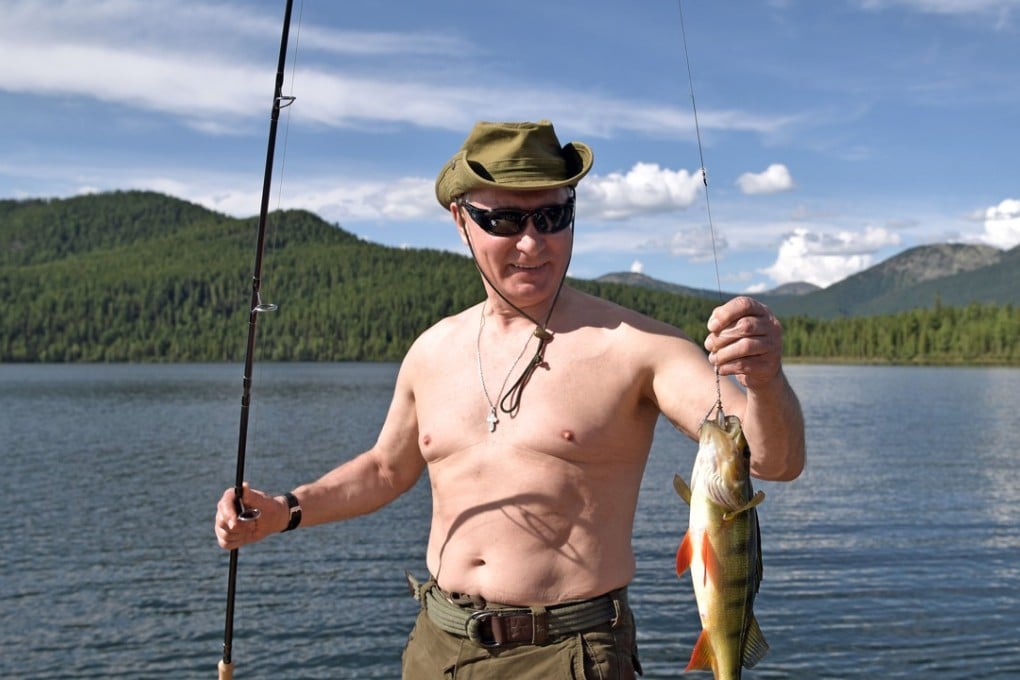 Russian President Vladimir Putin holds a fish he caught during a mini-break in the Siberian Tyva region. Photo: AP