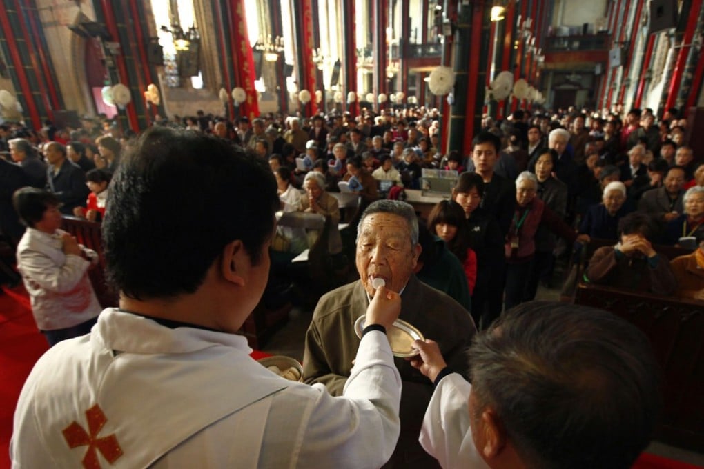 A man receives Holy Communion at mass at the state-controlled Xishiku Cathedral in Beijing. Photo: Reuters