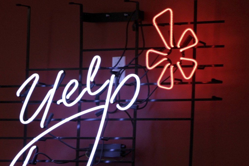 The logo of the online review website Yelp is shown in neon on a wall at the company's Manhattan offices in New York. Grubhub plans to gobble up another online food-ordering rival: This time it's Yelp's Eat24 business. Photo: AP