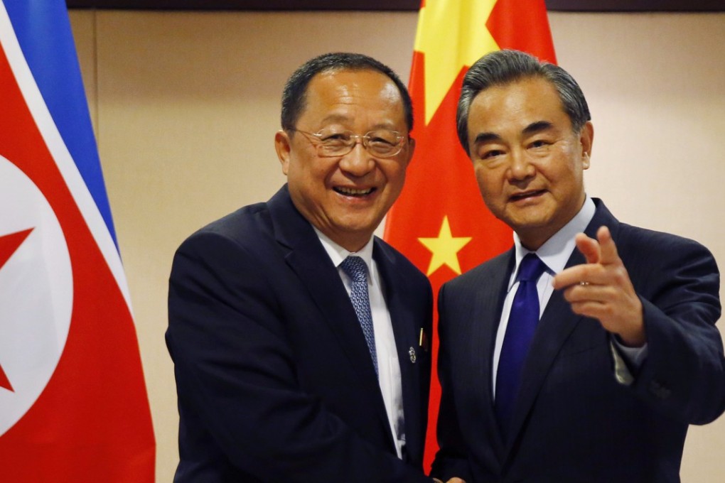North Korean Foreign Minister Ri Yong-ho, left, smiles as he greets his Chinese counterpart Wang Yi prior to their meeting in Manila on Sunday. Photo: AP