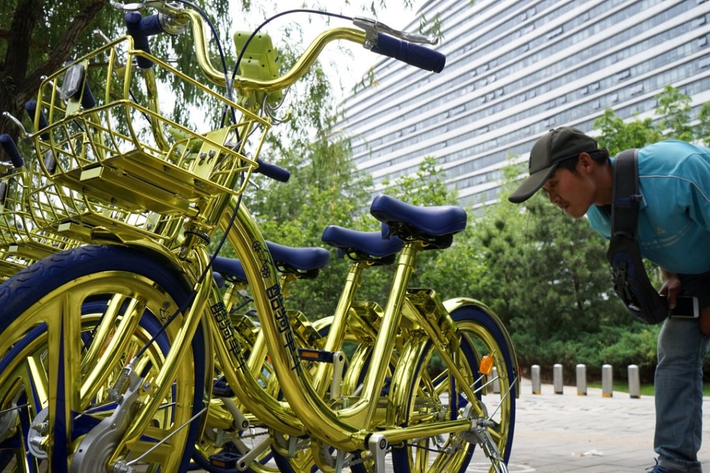 A Beijing man contemplates using a bike, rather than a bus or car. Photo: Reuters