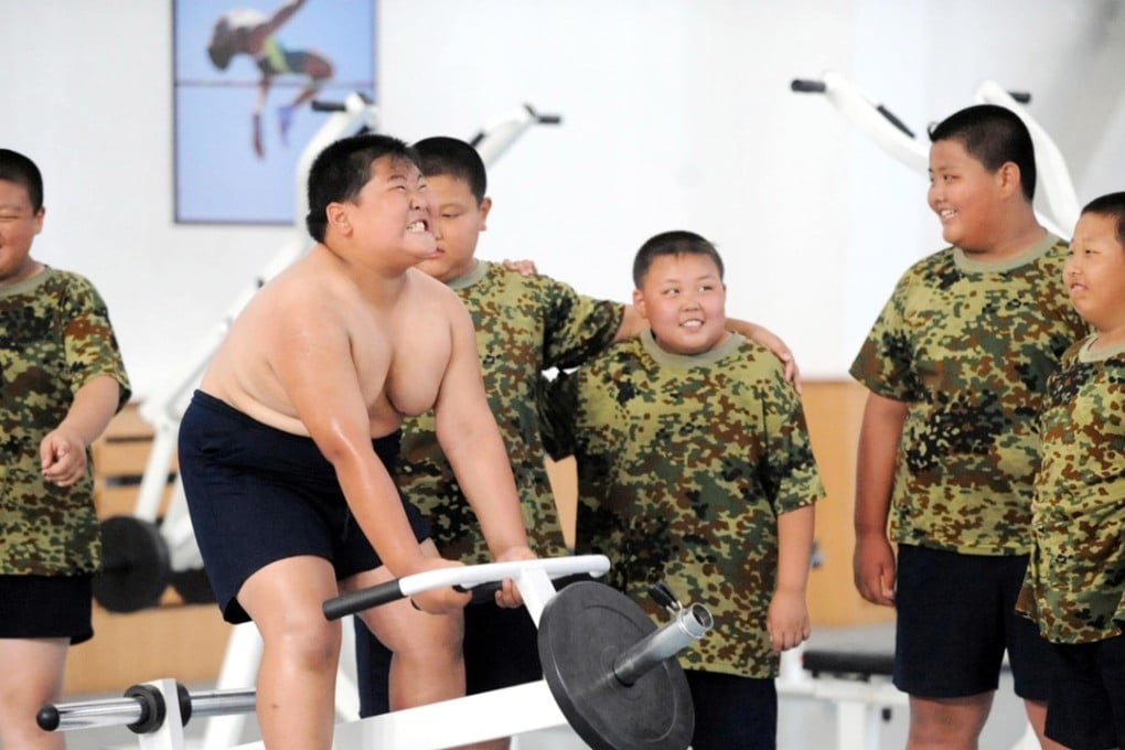 Obese Chinese children exercise in a fitness centre during a military training summer camp at the Shenyang Artillery College in Shenyang city, northeast China’s Liaoning province. Photo: Imaginechina