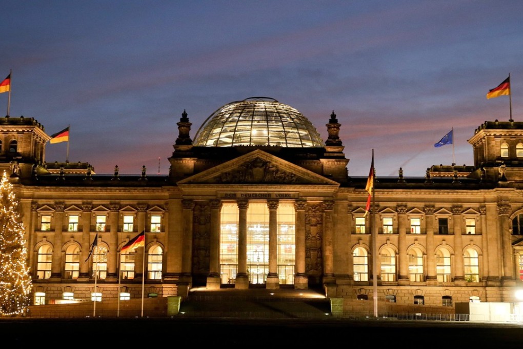 German police officers saw the two men, aged 36 and 49, taking photos of each other making “Heil Hitler” gestures in front of the Reichstag. Photo: EPA