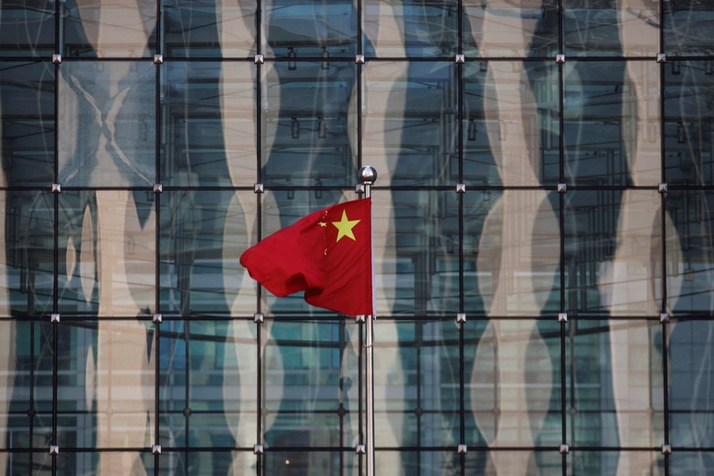 A Chinese national flag at the headquarters of a commercial bank on a financial street near the headquarters of the People's Bank of China, China's central bank. Photo: Reuters