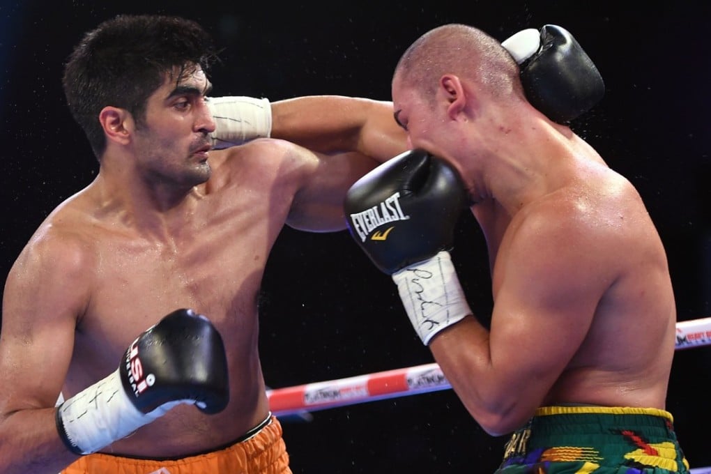 Indian boxer and WBO Asia-Pacific super-middleweight champion Vijender Singh throws a punch at WBO Oriental champion Zulpikar Maimaitiali. Photo: AFP