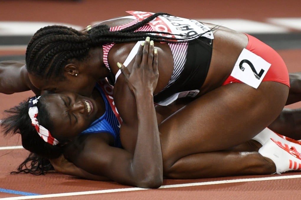 Tori Bowie of the US is congratulated by Kelly-Ann Baptiste of Trinidad and Tobago after winning the 100 metres final. Photo: EPA