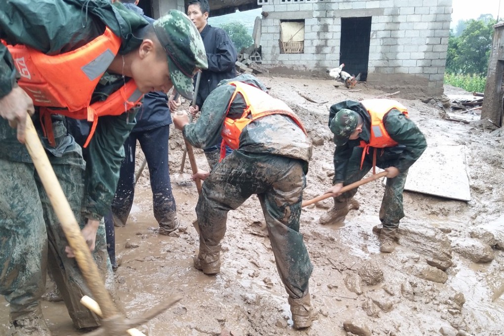 Rescue workers dig at the disaster site after a landslide hit the village of Gengdi in Qiaowo town on Tuesday. Photo: Xinhua