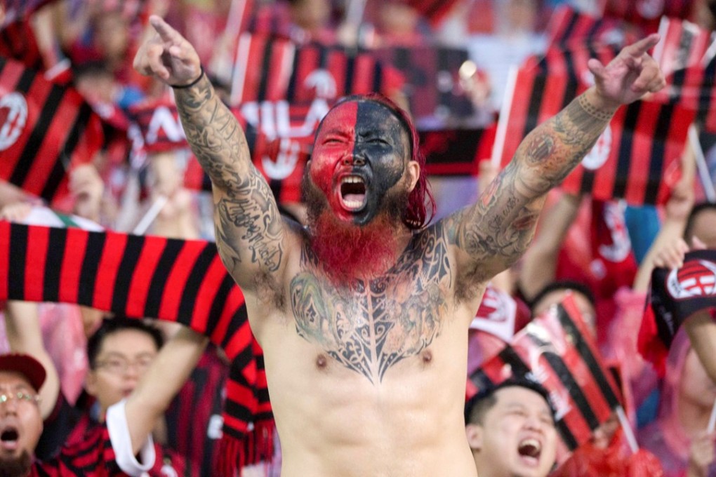 Fans of AC Milan cheer for their team against Borussia Dortmund in Guangzhou. Photo: Reuters