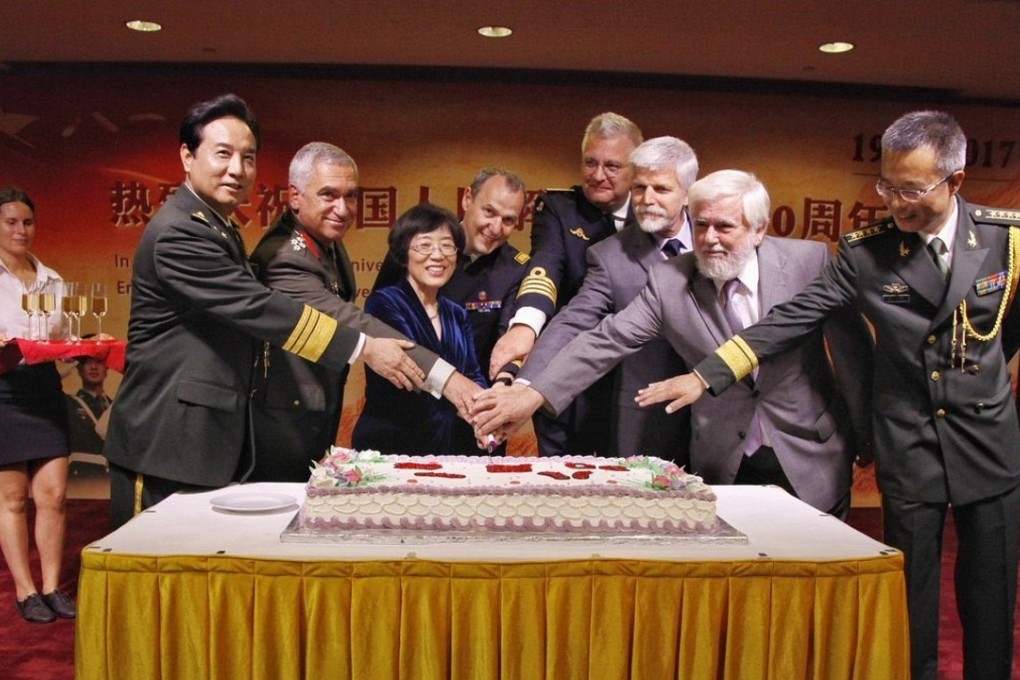 Prince Laurent of Belgium, fourth from right, helps cut a cake to celebrate the 90th anniversary of the founding of the Chinese PLA, at an event at the Chinese embassy in Brussels on July 20. Photo: Twitter / @Laurent_of_B
