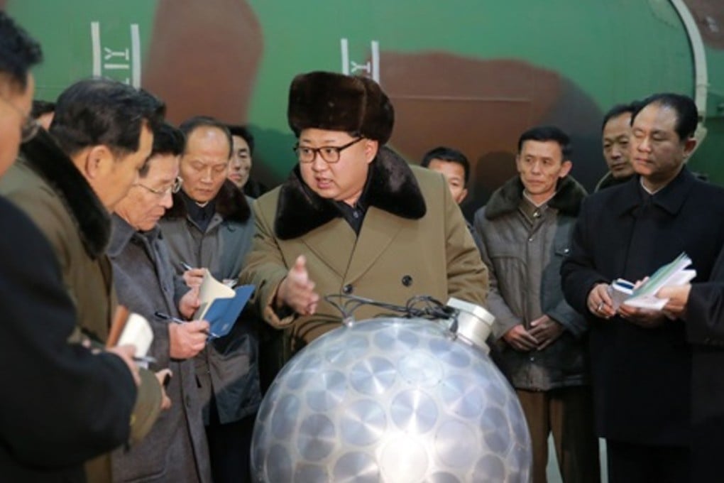 North Korean leader Kim Jong-un (centre) with what was purported to be a miniaturised nuclear warhead, in a photo released by state media in March 2016. Photo: KCNA