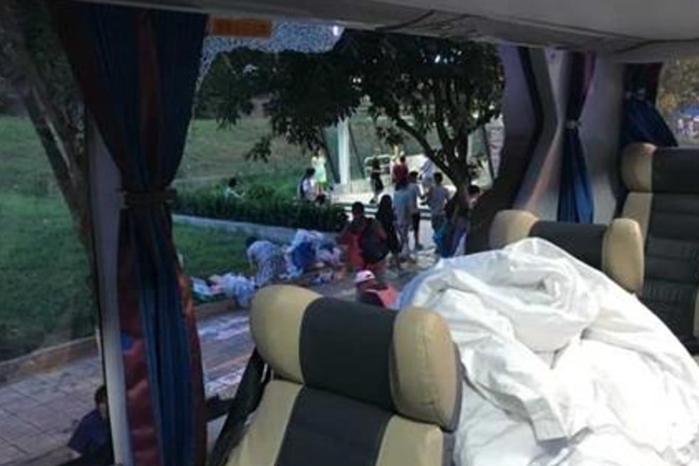 Several large rocks hit the tour bus the couple was travelling on, smashing the window beside them. Photo: Handout