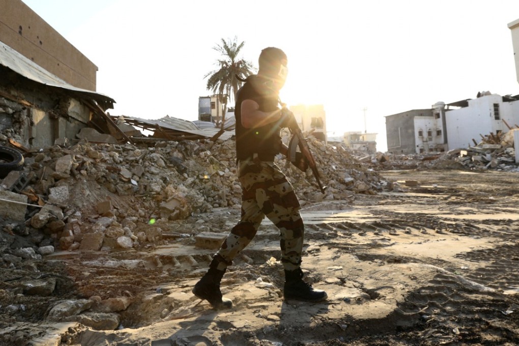 A member of Saudi Special Forces walks in the town of Awamiya following a security campaign against Shi'ite Muslim gunmen, in the eastern part of Saudi Arabia on Wednesday. Photo: Reuters
